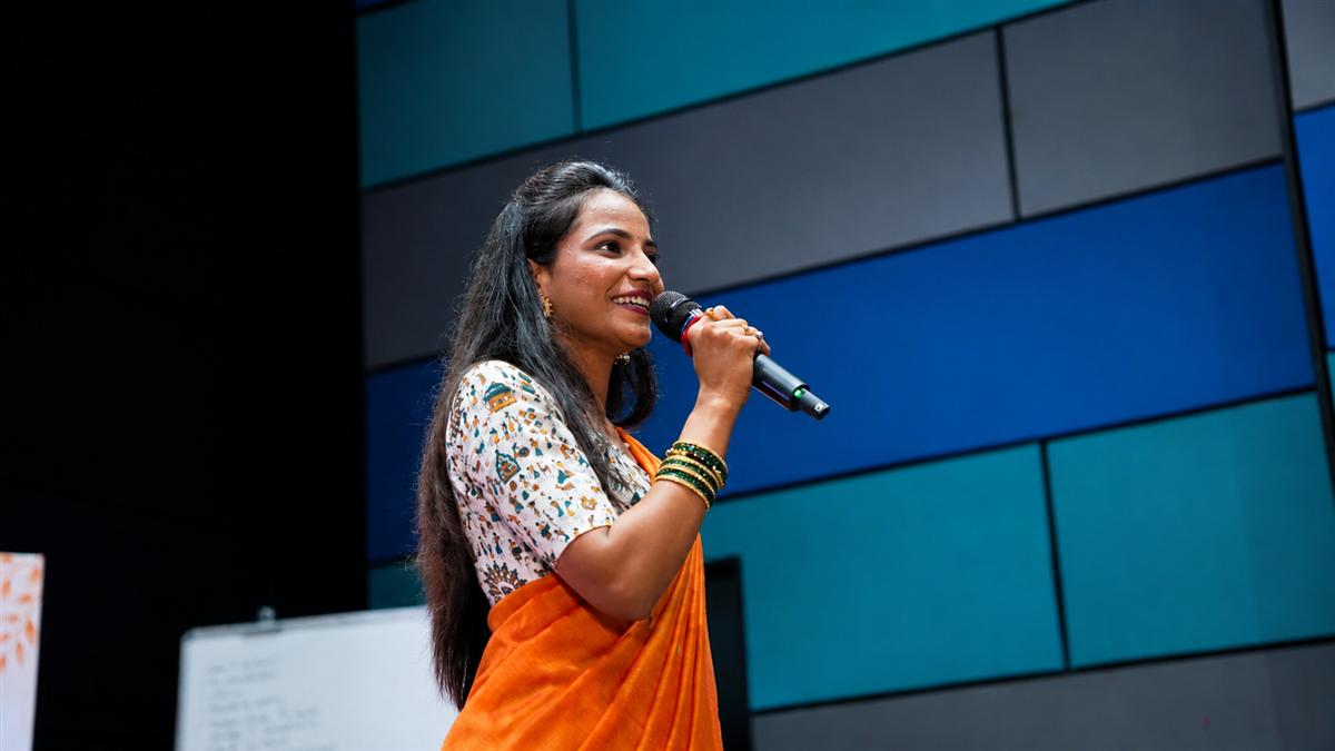 Snehal speaking at a previous Snehyoga event